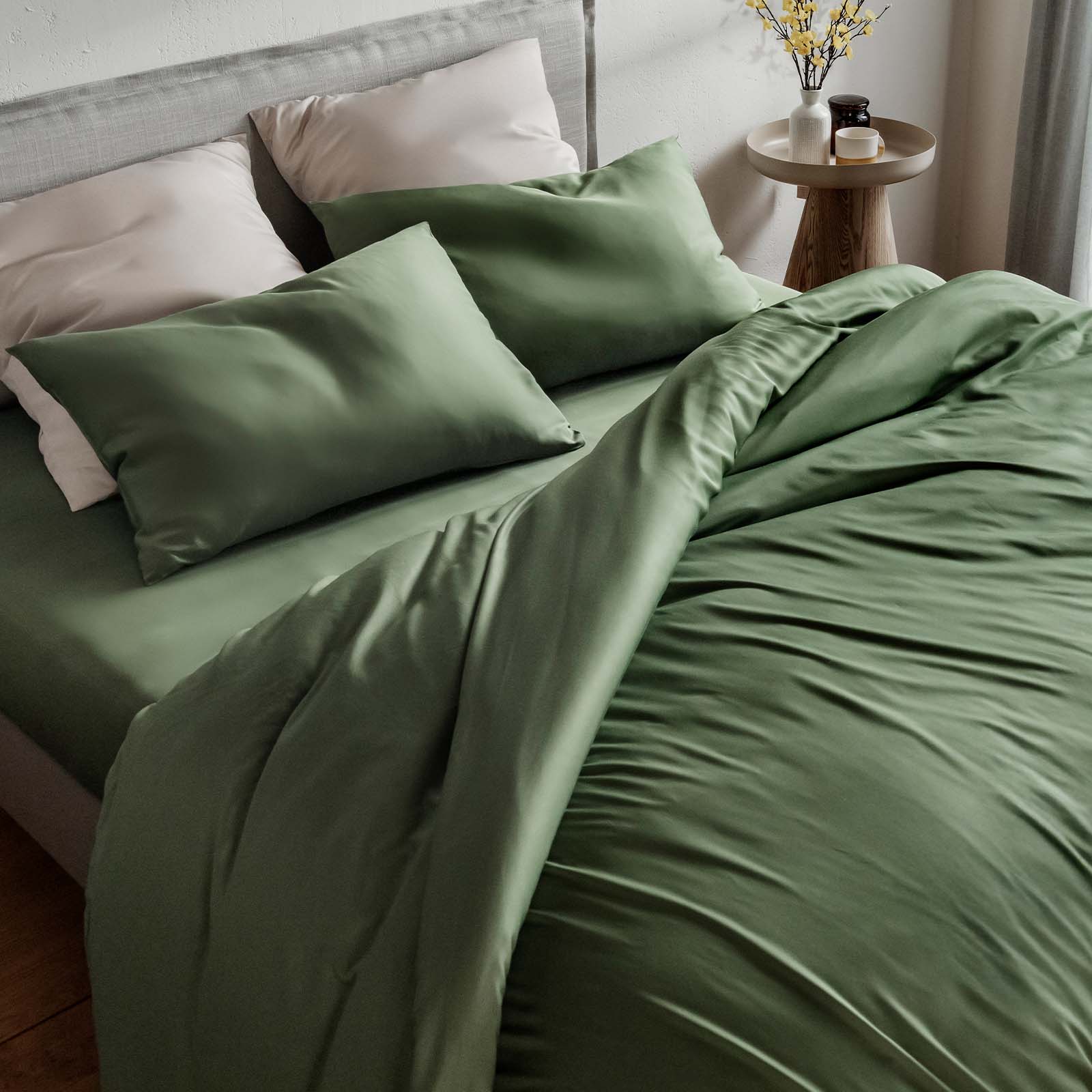 Olive green bedding set on a bed in a bedroom setting