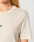 Natural raw white cotton t-shirt with a green City to Ocean logo worn by a woman on a white background