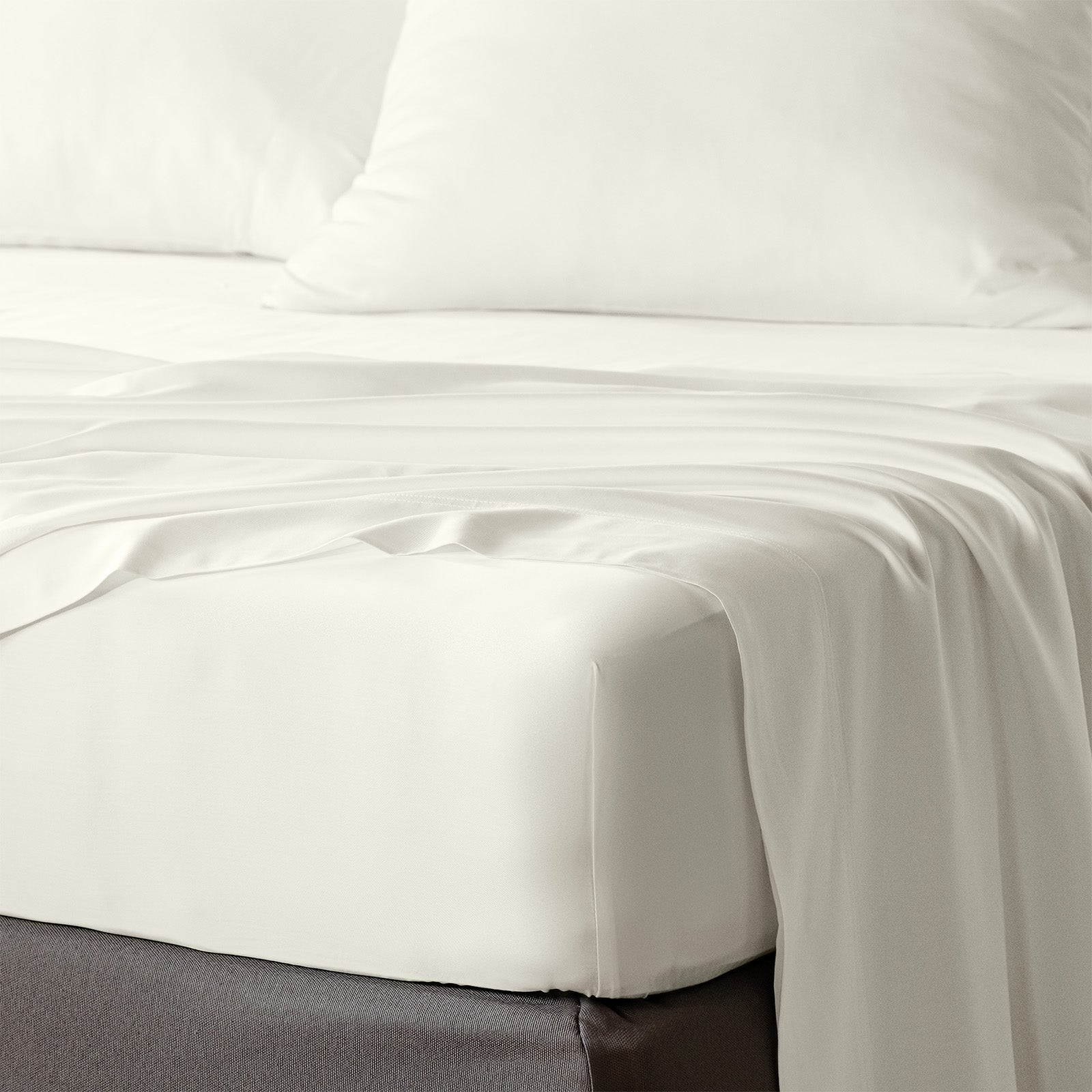 bambaw cozy bamboo bed sheets close up on a bed with fitted sheets and pillows in ivory colour