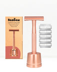 Bambaw Rose gold safety razor with stand and packaging and additional blades on a white background