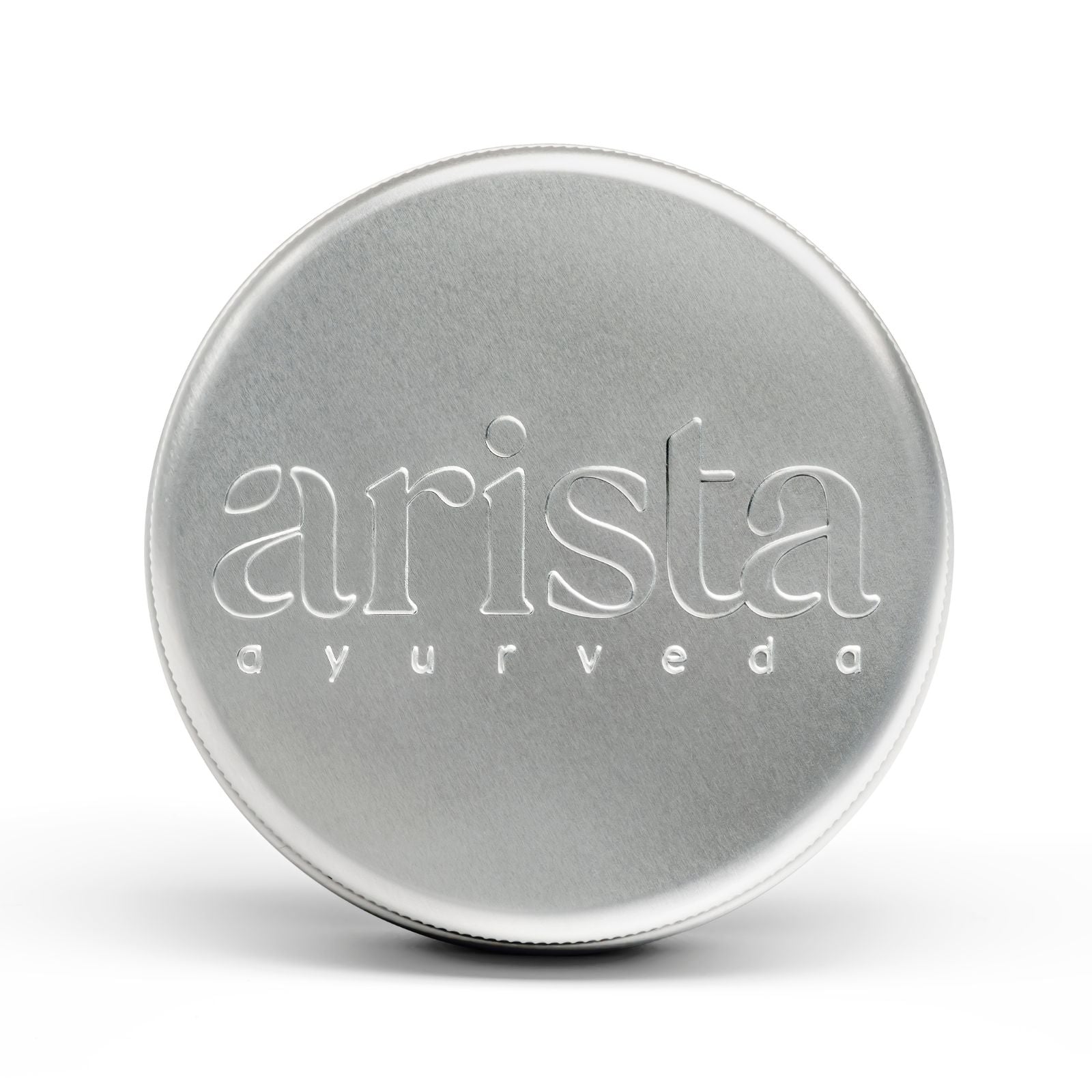 Silver shampoo box tin with 'arista ayurveda' branding on a white background