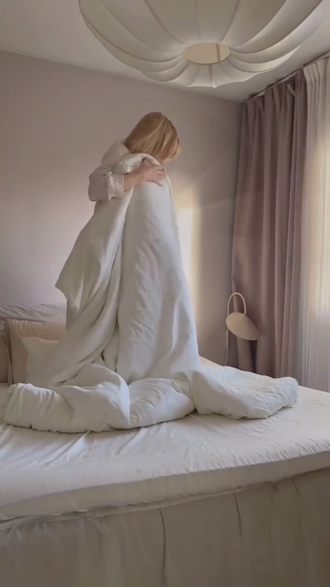 woman making a bed with bamboo ivory duvet cover set